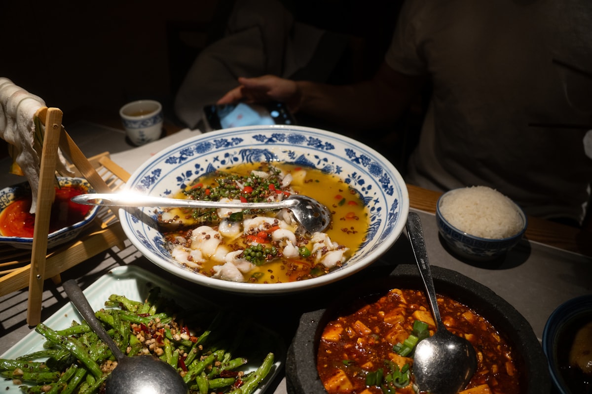 A Chengdu dinner done right — stone-pot mapo tofu, fish in peppercorn broth, dry-fried green beans, rice