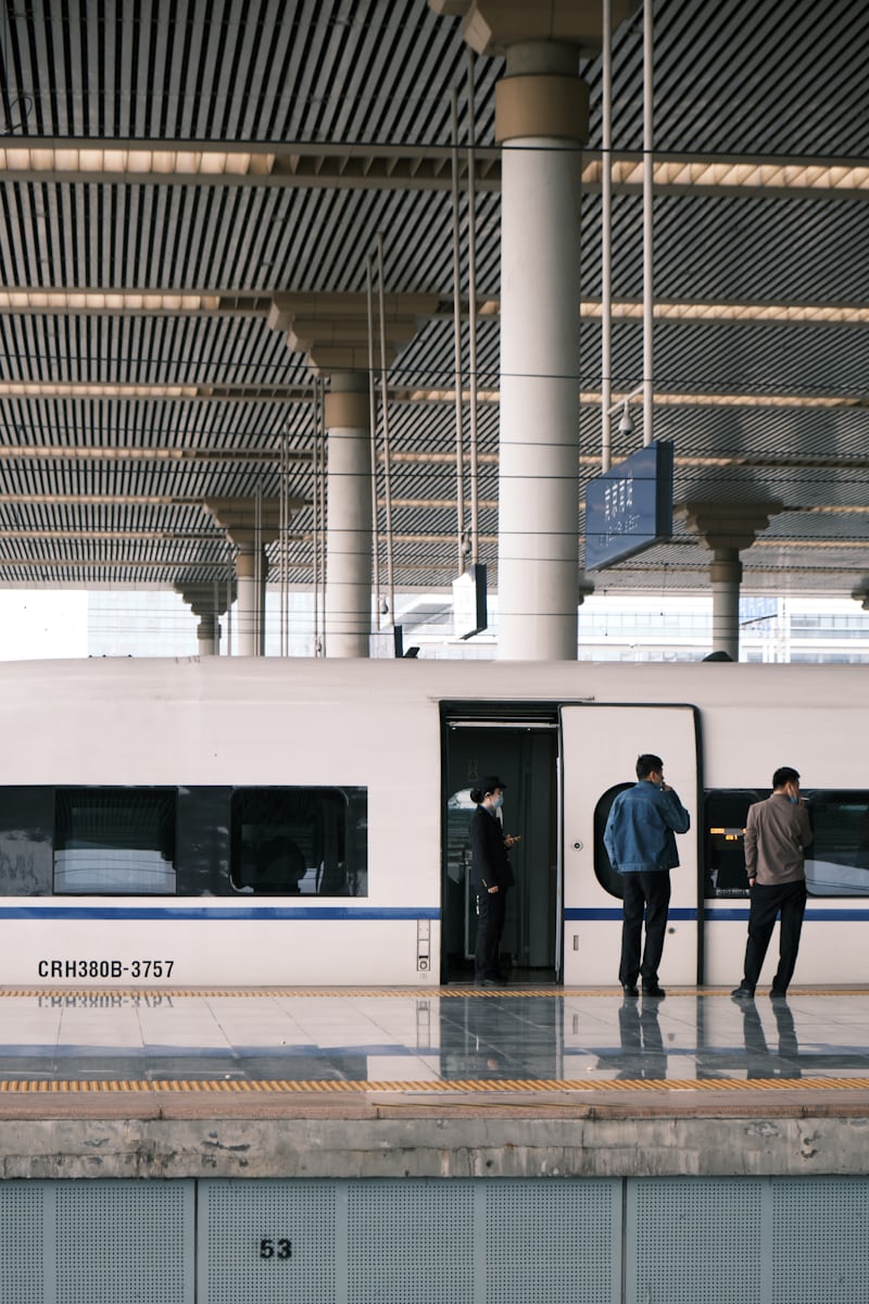 Passengers step aboard a CRH380B train at the platform door — board early, Chinese trains leave exactly on time