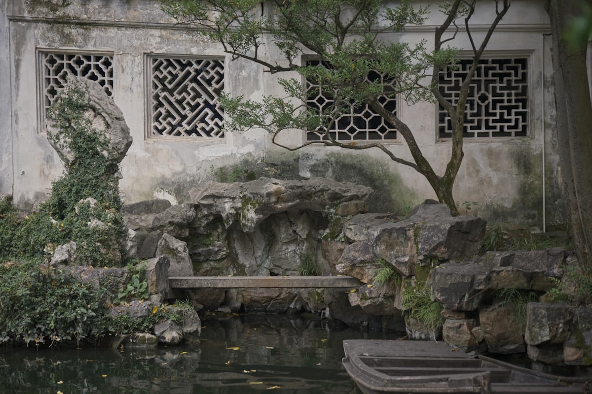Lattice windows and rockery pools in the Lingering Garden — famous for its rock and water features