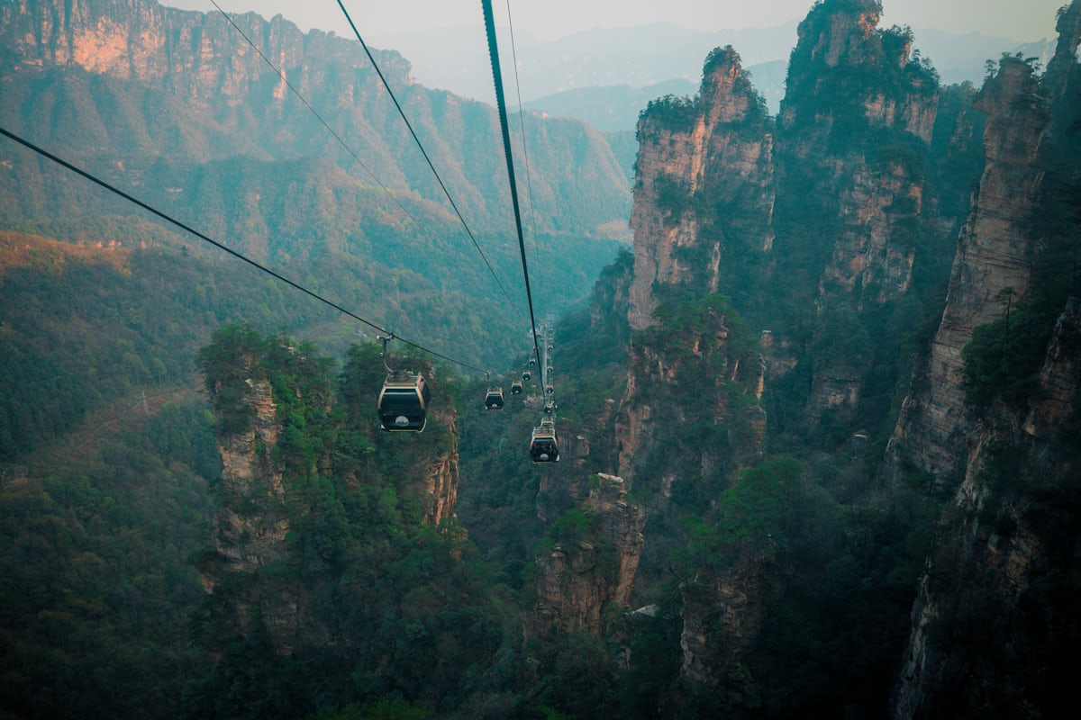 Cable cars glide between Zhangjiajie's sandstone pillars — every major section of the park is cable-car accessible