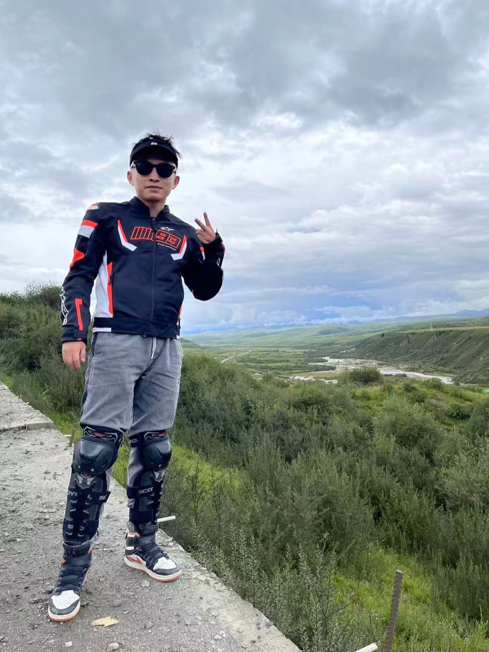Suited up at a pull-off on the climb, river valley far below