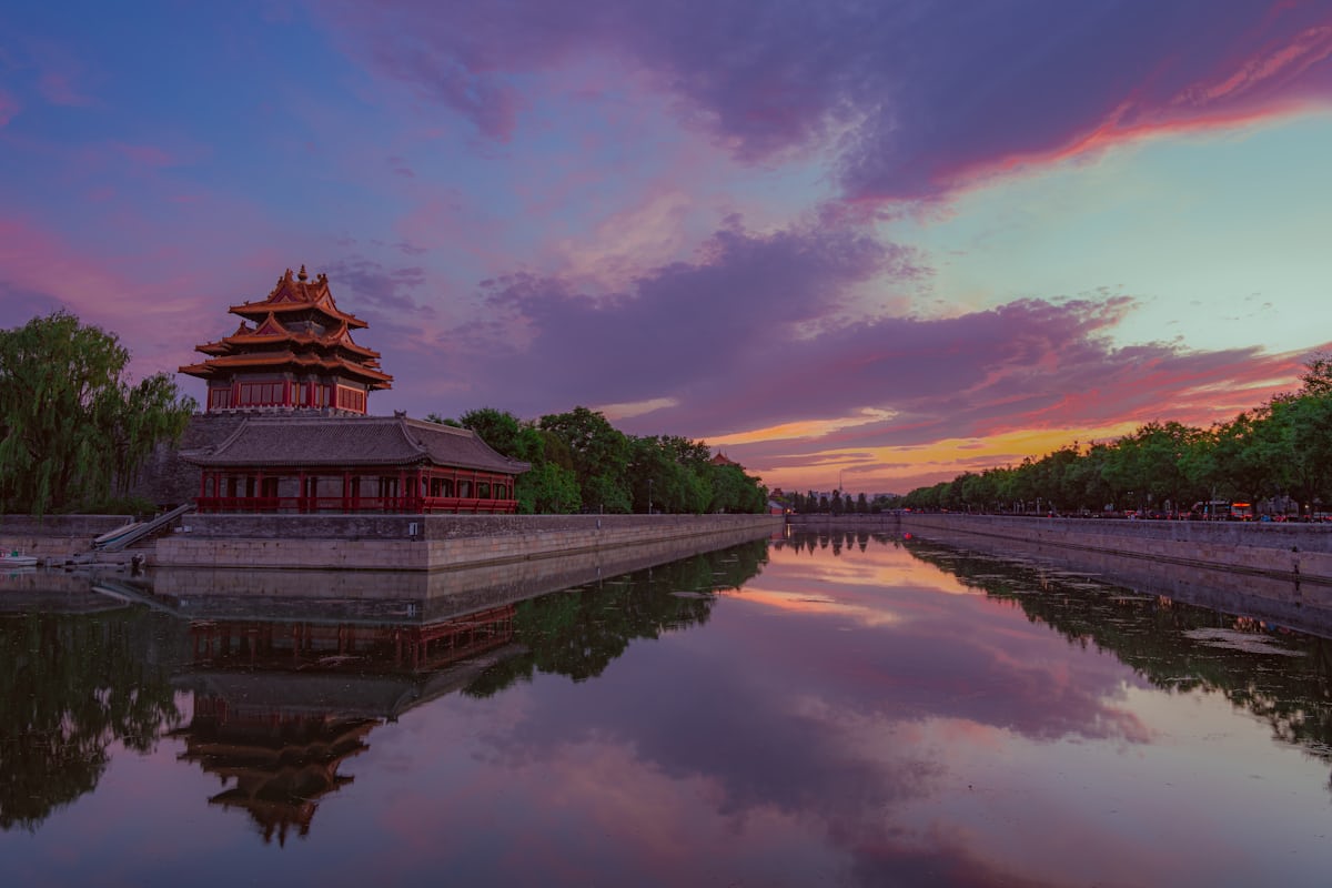 Sunset over the Forbidden City's corner tower and moat — a first Beijing trip rewards the prep work below